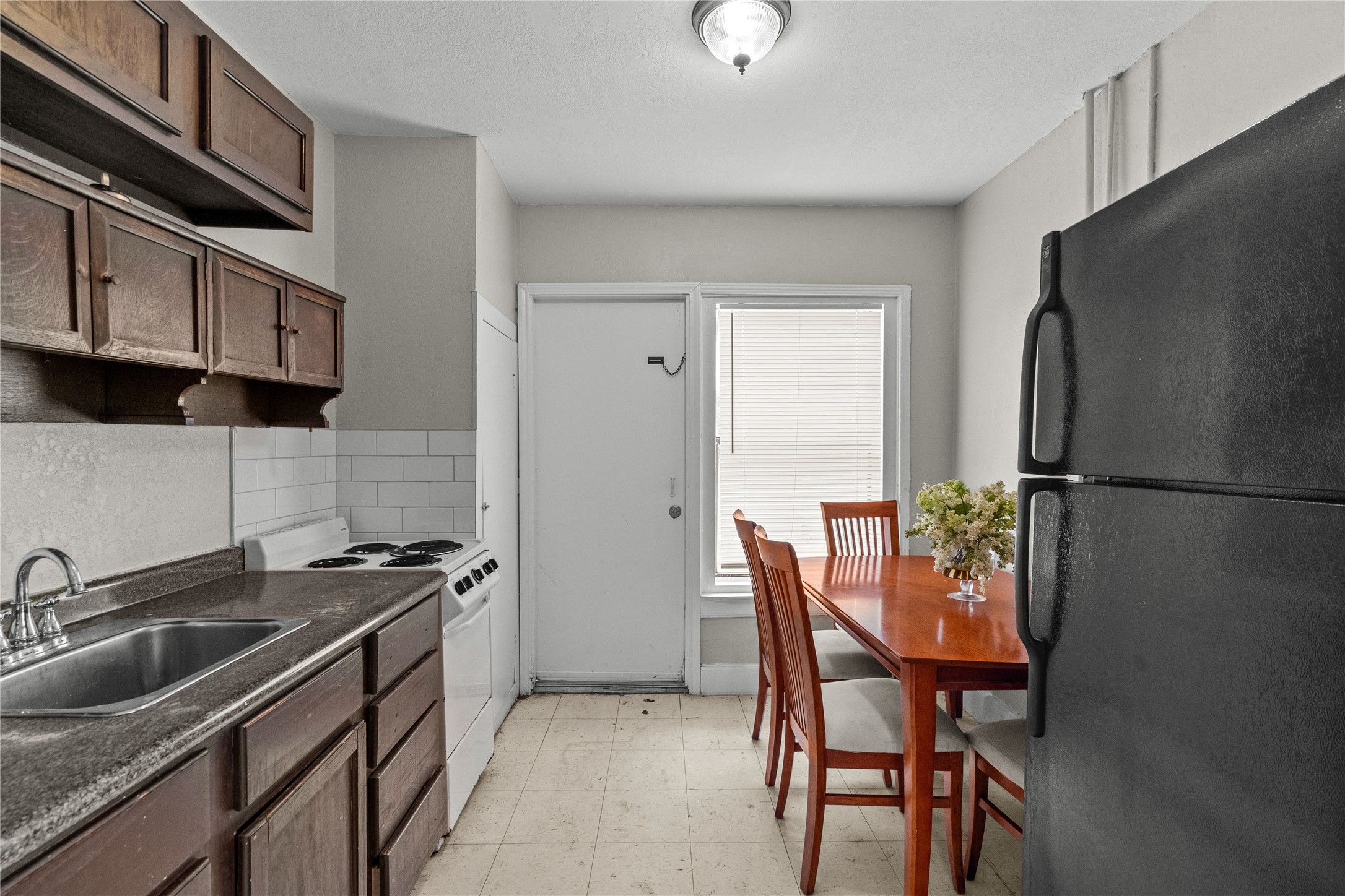 814 3rd Avenue North, Unit 46 Texas City, TX 77590 - Photo 5 of 11 a kitchen with stainless steel appliances a refrigerator a sink a stove a table and chairs