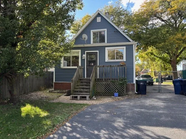 a front view of a house with yard and green space