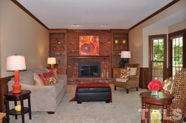 708 Sandown Place Raleigh, NC 27615 - Photo 2 of 25 a living room with furniture and a fireplace