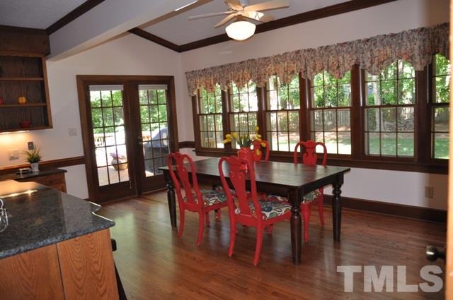 708 Sandown Place Raleigh, NC 27615 - Photo 11 of 25 a view of a dining room with furniture large windows and wooden floor
