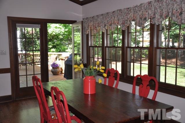 708 Sandown Place Raleigh, NC 27615 - Photo 12 of 25 a view of a dining room with furniture large windows and wooden floor