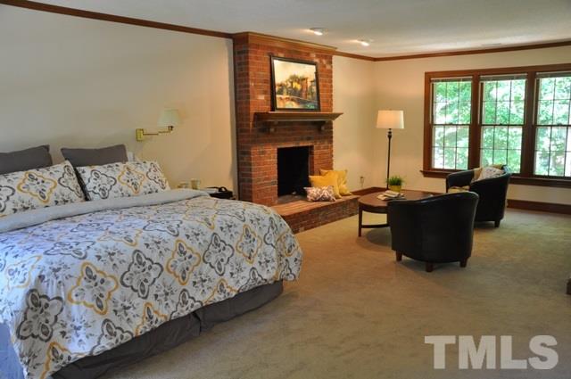 708 Sandown Place Raleigh, NC 27615 - Photo 15 of 25 a spacious bedroom with a bed and a couch