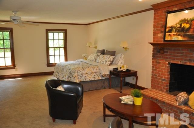 708 Sandown Place Raleigh, NC 27615 - Photo 16 of 25 a living room with furniture and a fireplace