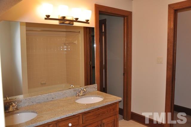 708 Sandown Place Raleigh, NC 27615 - Photo 20 of 25 a bathroom with a sink and a mirror