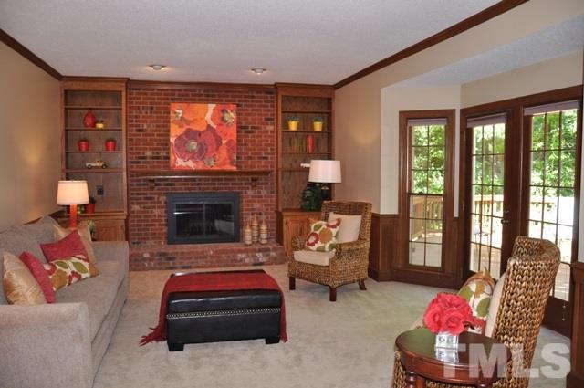 708 Sandown Place Raleigh, NC 27615 - Photo 3 of 25 a living room with furniture fireplace and flat screen tv