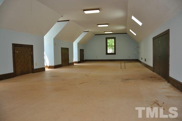 708 Sandown Place Raleigh, NC 27615 - Photo 22 of 25 an empty room with windows and fireplace
