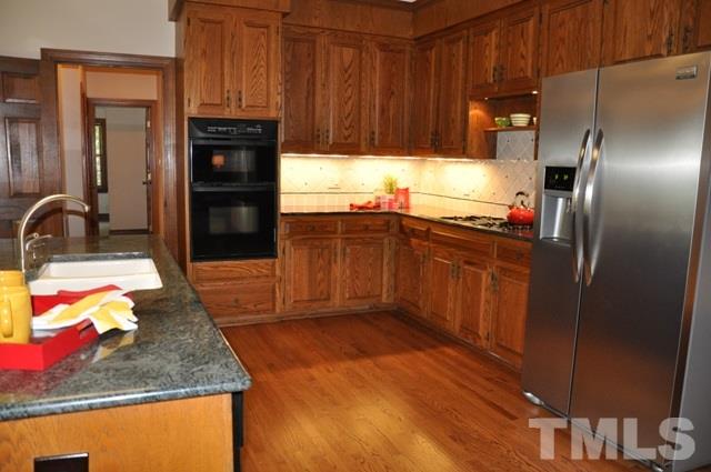 708 Sandown Place Raleigh, NC 27615 - Photo 10 of 25 a kitchen with stainless steel appliances granite countertop a refrigerator and a sink