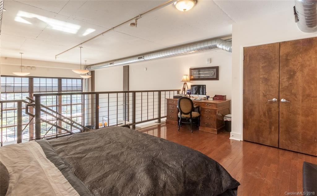 715 North Graham Street, Unit 604 Charlotte, NC 28202 - Photo 12 of 21 a bed room with a bed and a chair