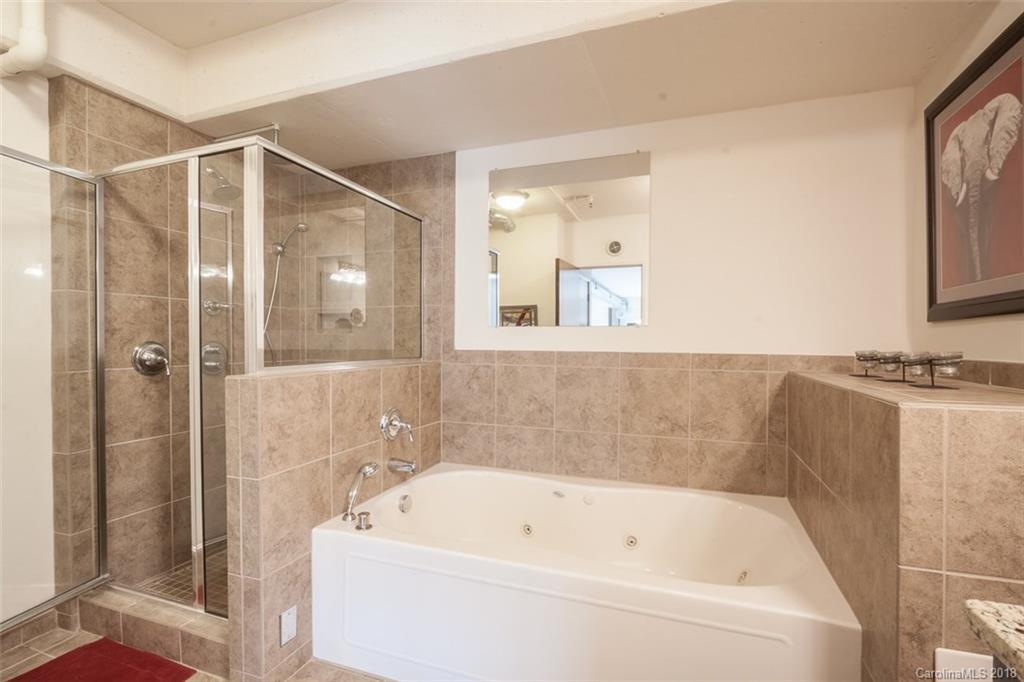 715 North Graham Street, Unit 604 Charlotte, NC 28202 - Photo 14 of 21 a bathroom with a bathtub and a shower