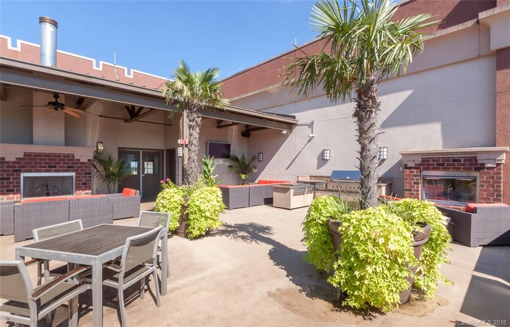 715 North Graham Street, Unit 604 Charlotte, NC 28202 - Photo 17 of 21 a view of a chairs and table in a patio