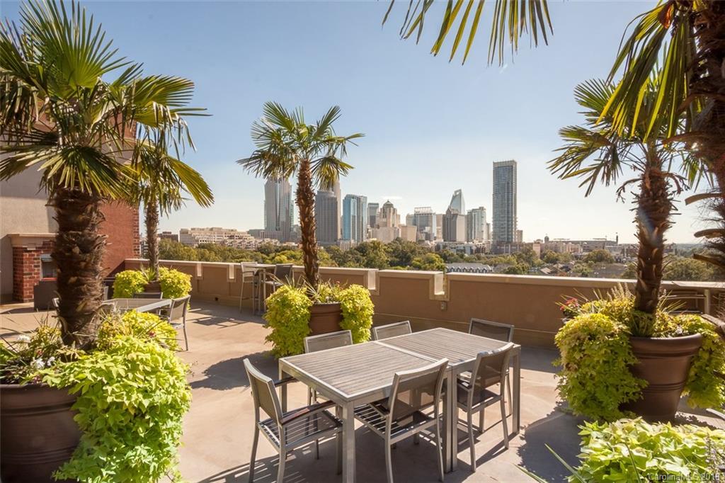 715 North Graham Street, Unit 604 Charlotte, NC 28202 - Photo 20 of 21 a patio with water view fountain and a dining table with chairs