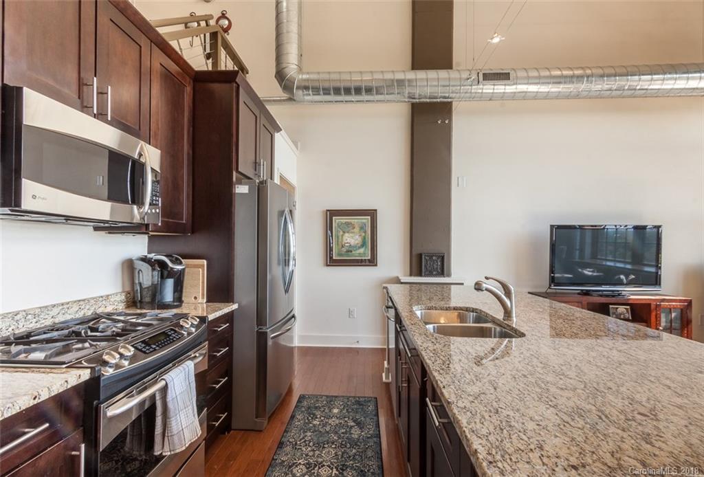 715 North Graham Street, Unit 604 Charlotte, NC 28202 - Photo 4 of 21 a kitchen that has a sink and a stove