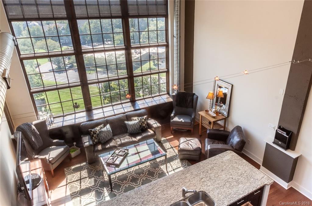715 North Graham Street, Unit 604 Charlotte, NC 28202 - Photo 9 of 21 a living room with furniture and floor to ceiling windows