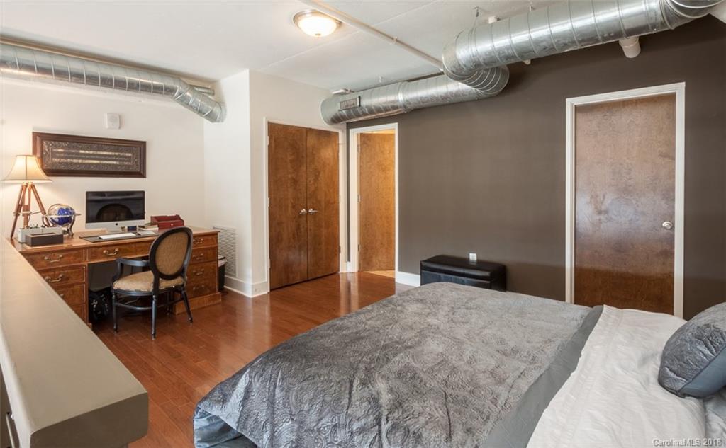 715 North Graham Street, Unit 604 Charlotte, NC 28202 - Photo 10 of 21 a bedroom with a bed and a desk