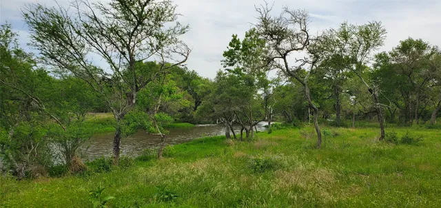 a view of a lake with green space