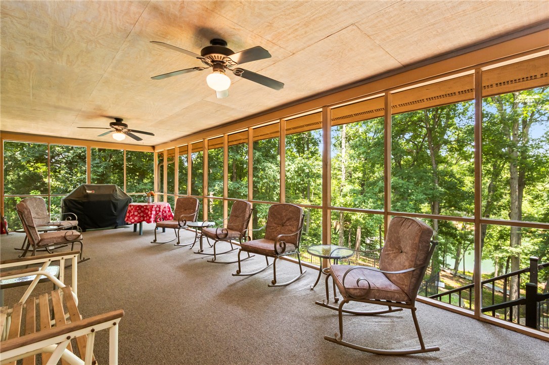 202 Plantation Point Anderson, SC 29625 - Photo 6 of 48 A spacious screened porch offers tranquil views of the surrounding natural landscape and distant water.