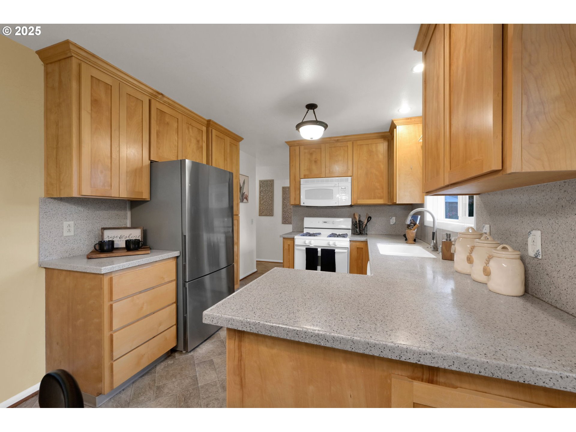 240 Dibblee Lane Eugene, OR 97404 - Photo 10 of 42 a kitchen with a refrigerator a stove a sink and cabinets