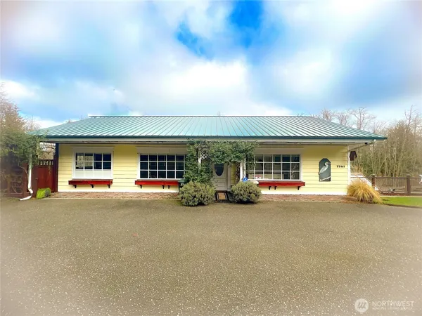 a view of a house with swimming pool and sitting area