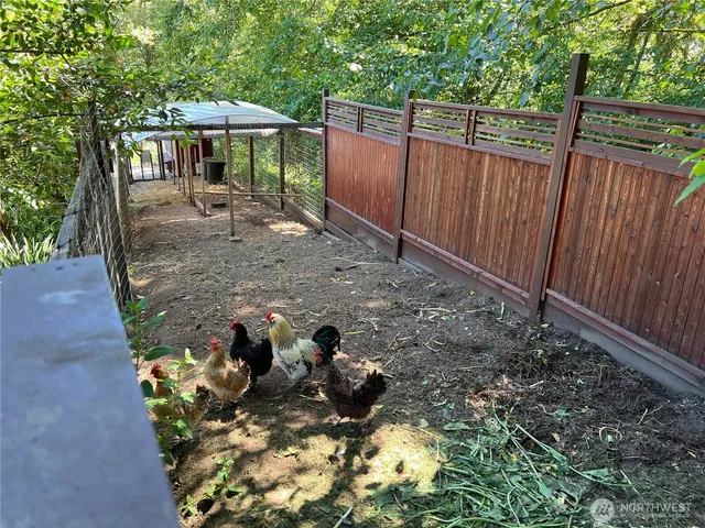 a room with stainless steel appliances wooden floor and large windows