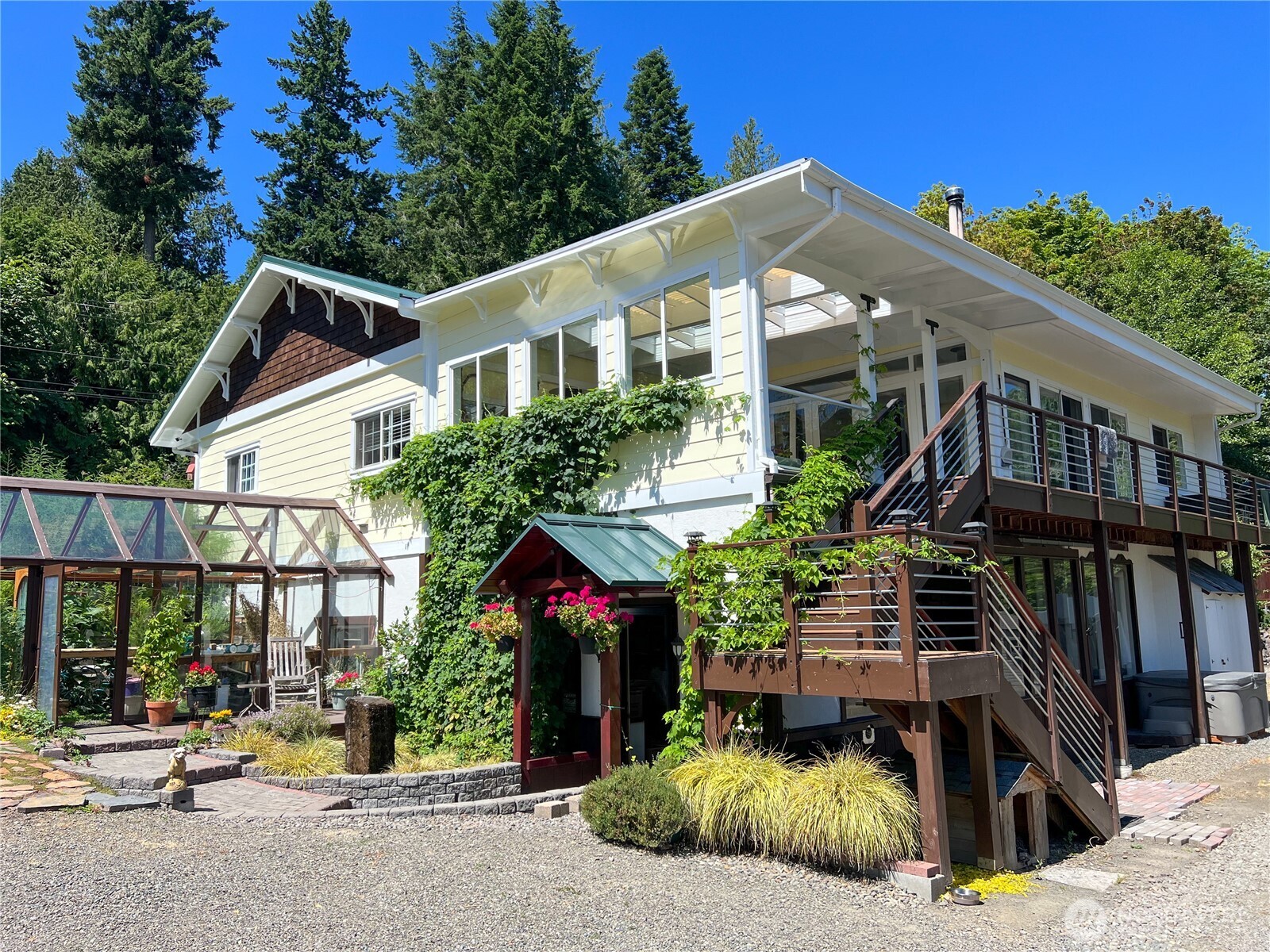 7251 Oak Bay Road Port Ludlow, WA 98365 - Photo 3 of 40 a front view of a house with garden