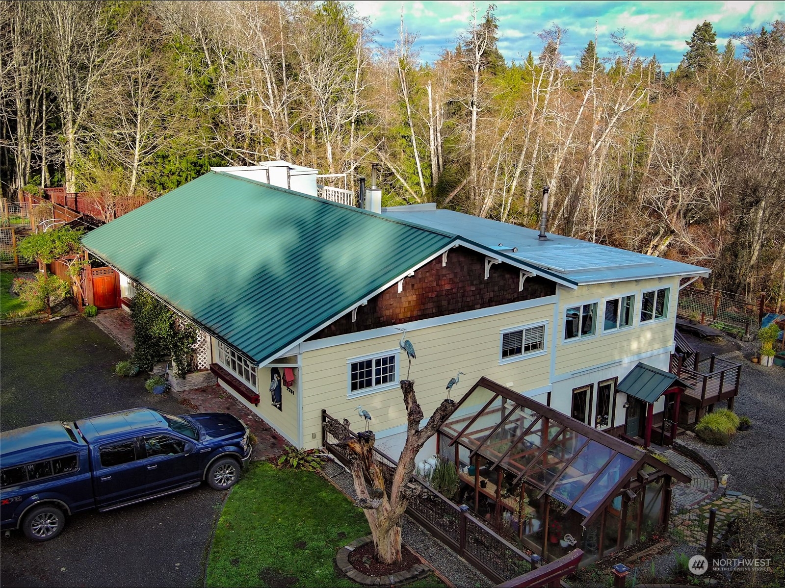 7251 Oak Bay Road Port Ludlow, WA 98365 - Photo 4 of 40 an aerial view of a house with swimming pool and large trees
