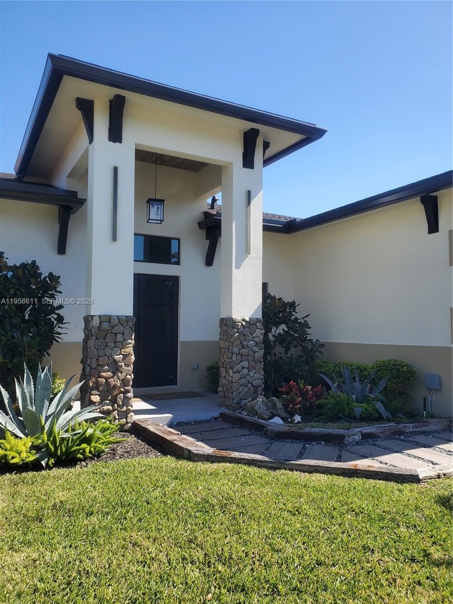 960 Rutherford Lane West Palm Beach, FL 33415 - Photo 2 of 5 a front view of a house with a yard