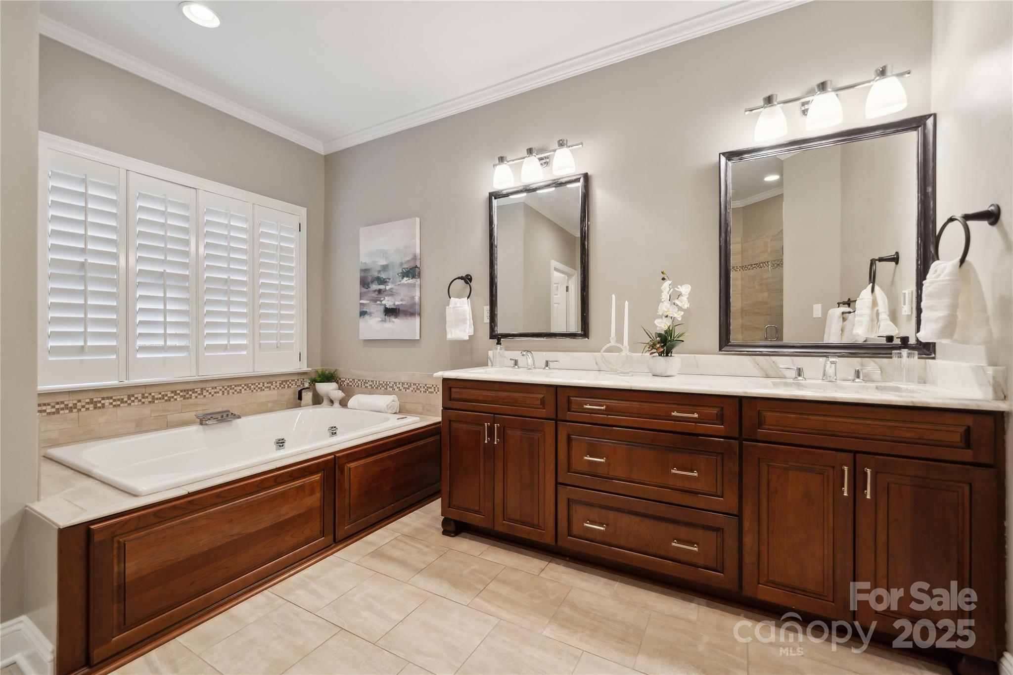 3932 Huckleberry Road Charlotte, NC 28210 - Photo 24 of 45 a spacious bathroom with a tub sink and mirror