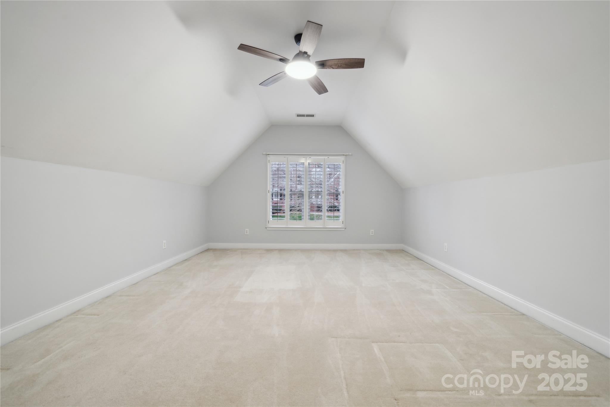 3932 Huckleberry Road Charlotte, NC 28210 - Photo 39 of 45 an empty room with a ceiling fan and window