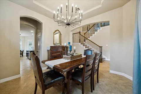 a view of a dining room with furniture and a chandelier