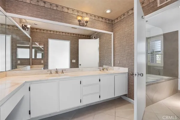 a bathroom with a double vanity sink and mirror