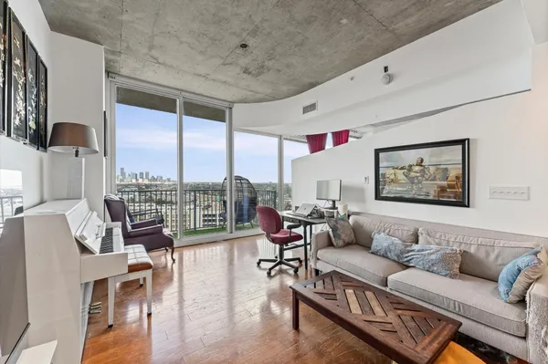 a living room with furniture and a large window
