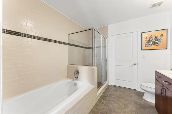 a bathroom with a granite countertop sink a toilet and a mirror