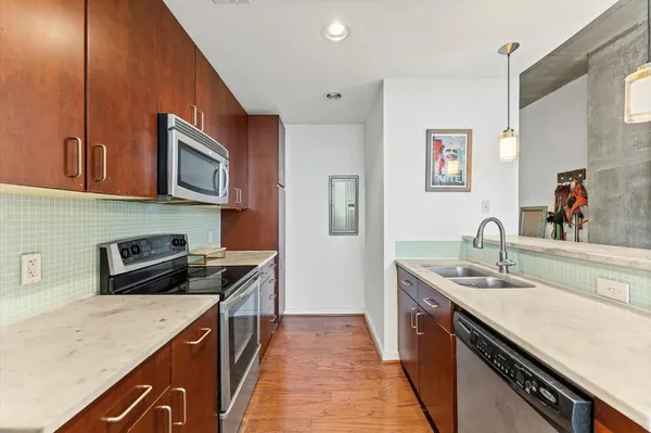 a kitchen with stainless steel appliances granite countertop a sink stove and cabinets