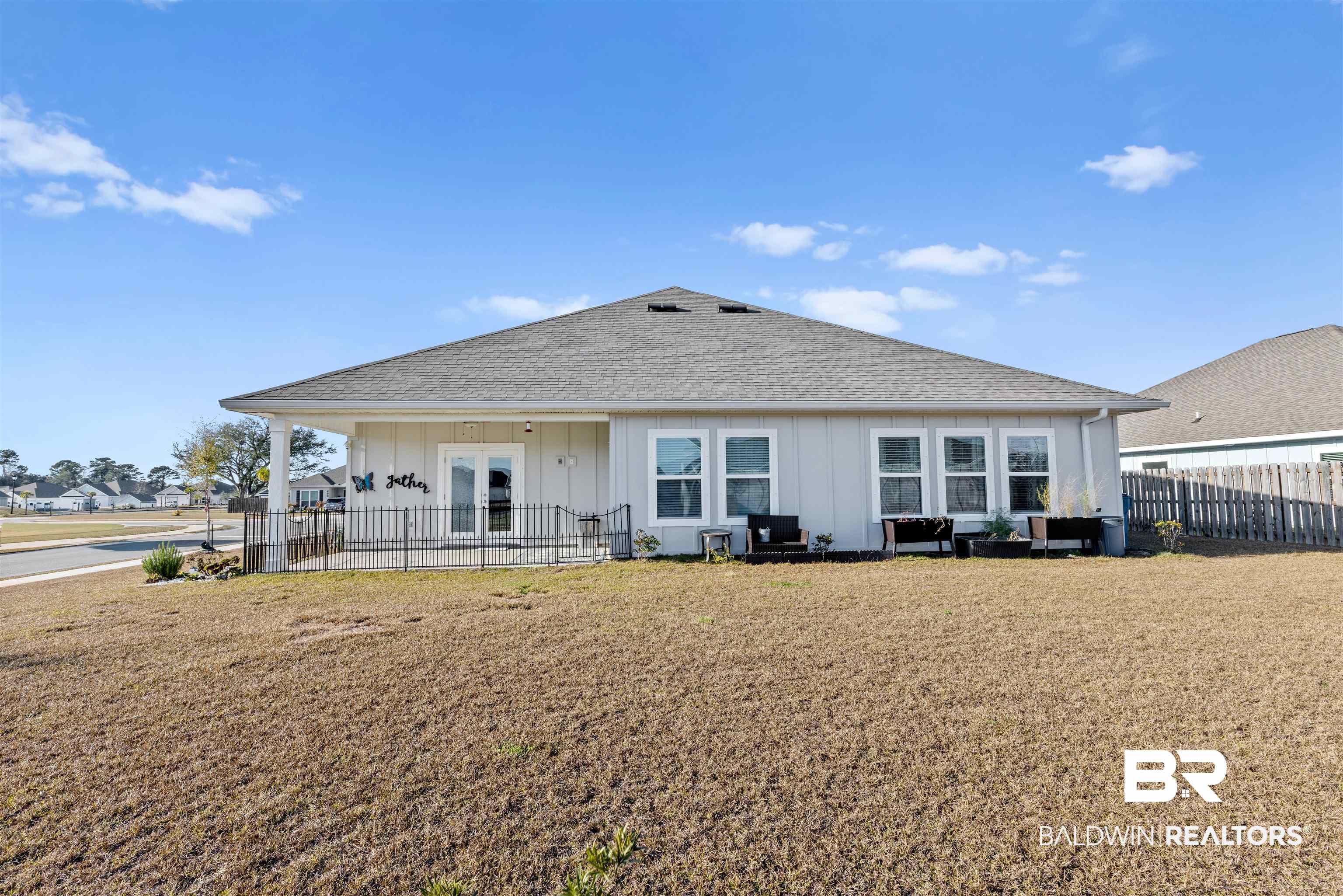 485 Shepard Street Gulf Shores, AL 36542 - Photo 45 of 53 Back of house with roof with shingles, board and batten siding, and a patio area