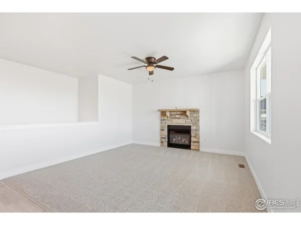 a view of empty room with ceiling fan