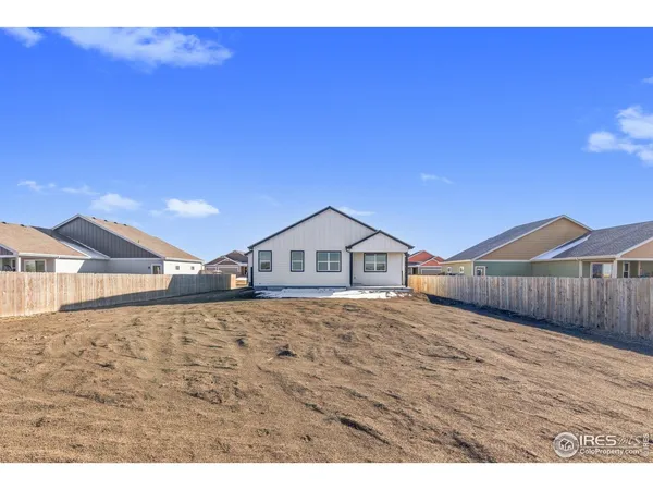 a view of a large house with a yard and large trees