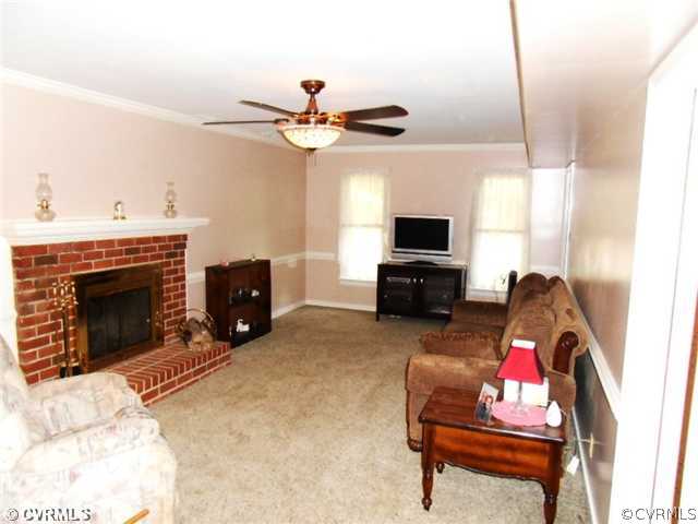 3002 Sagewood Road Midlothian, VA 23112 - Photo 3 of 10 a living room with furniture a fireplace and a flat screen tv