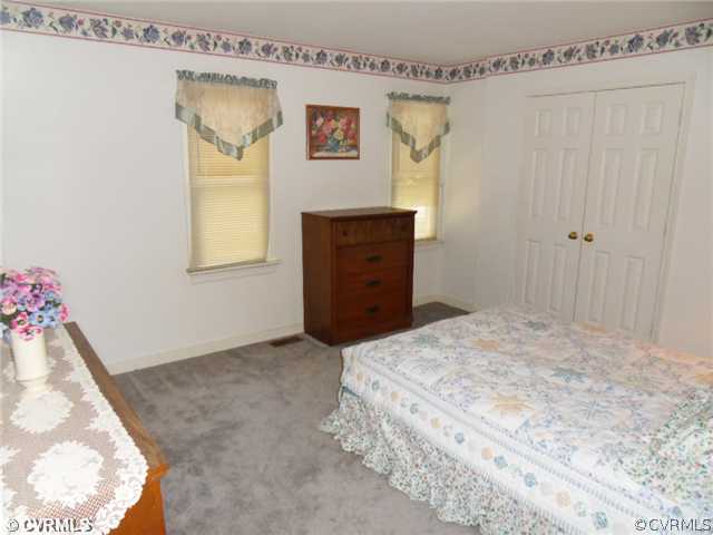 3002 Sagewood Road Midlothian, VA 23112 - Photo 8 of 10 a bedroom with a bed and a dresser