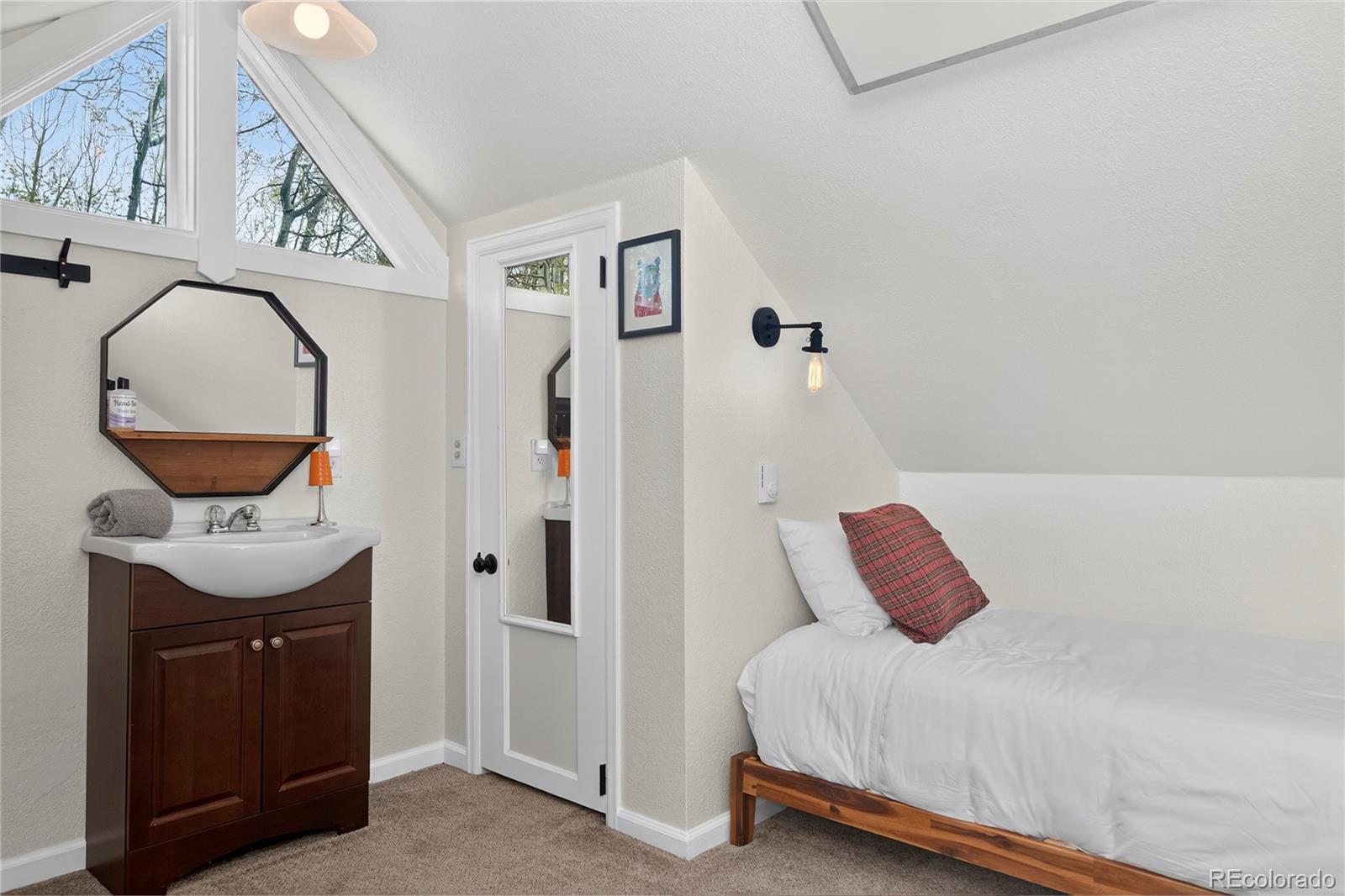 327 Vasquez Road, Unit E1 Winter Park, CO 80482 - Photo 39 of 43 a bedroom with a bed and a mirror
