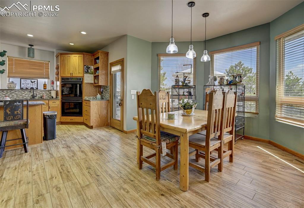 5910 McCart Ranch Circle Elizabeth, CO 80107 - Photo 10 of 50 a view of a dining room with furniture window and wooden floor