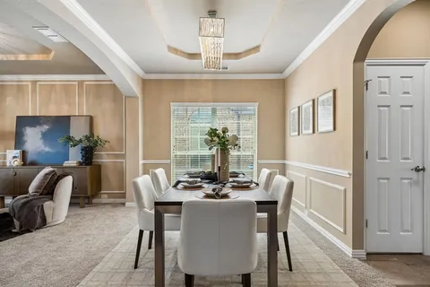 a dining room with furniture a chandelier and window
