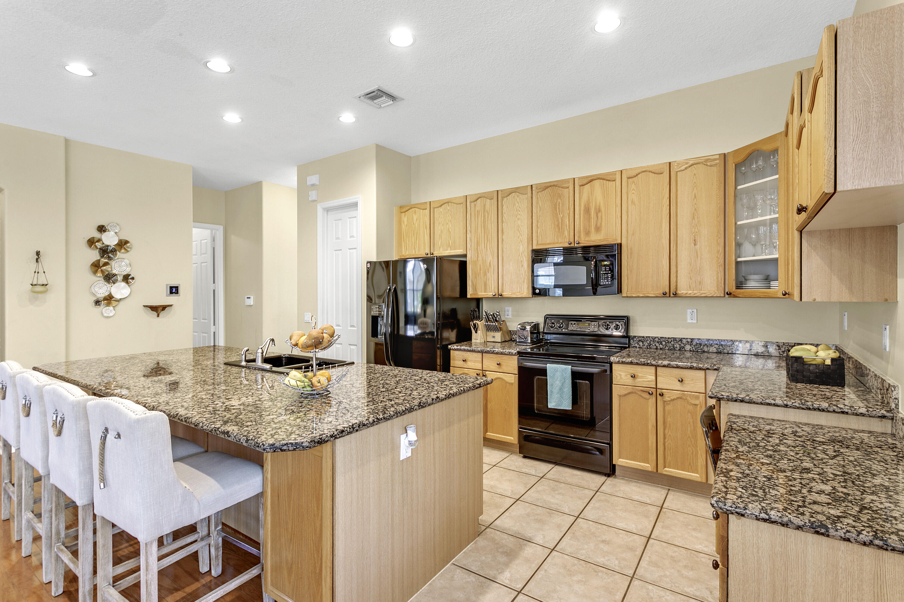 a kitchen with granite countertop stainless steel appliances a stove sink and microwave