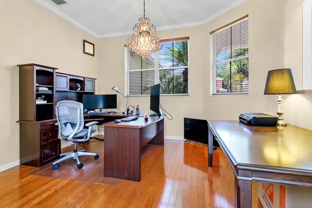 a view of a workspace with furniture and a window