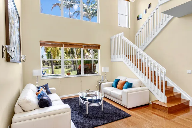 a living room with furniture and a window with white walls