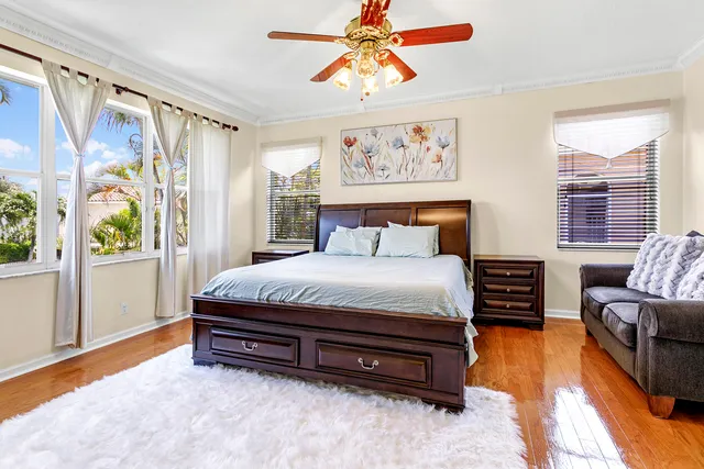a spacious bedroom with a bed and a chandelier