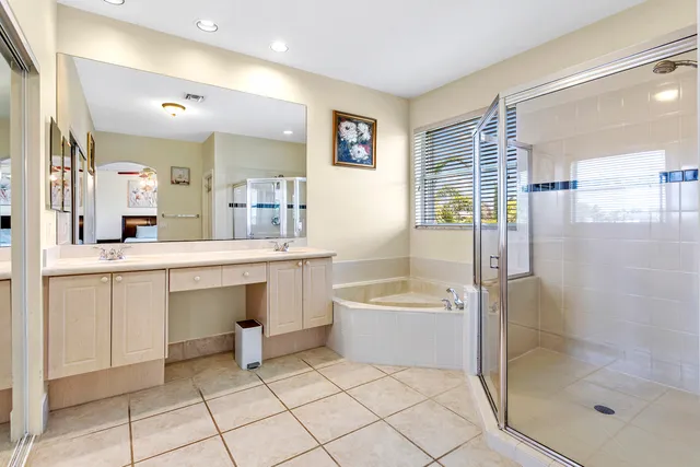 a bathroom with a bathtub shower sink vanity and toilet