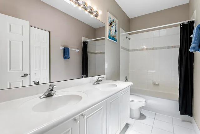 a bathroom with a bathtub shower sink vanity and toilet