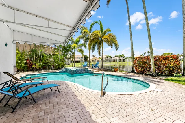 a view of swimming pool with chairs