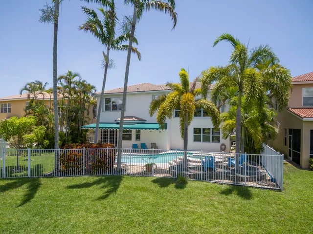 a front view of a house with a yard table and chairs