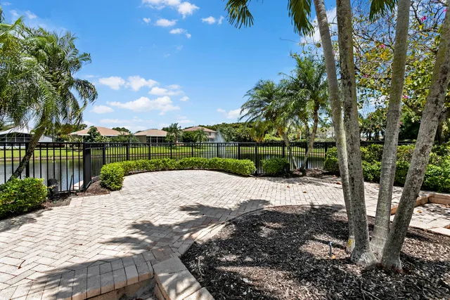 a living room with couch a dining table and a chandelier